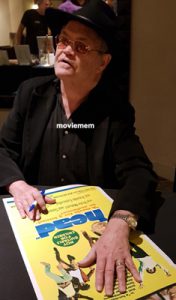 MICKY DOLENZ The Monkees signing a Daybill Movie poster for HEAD image